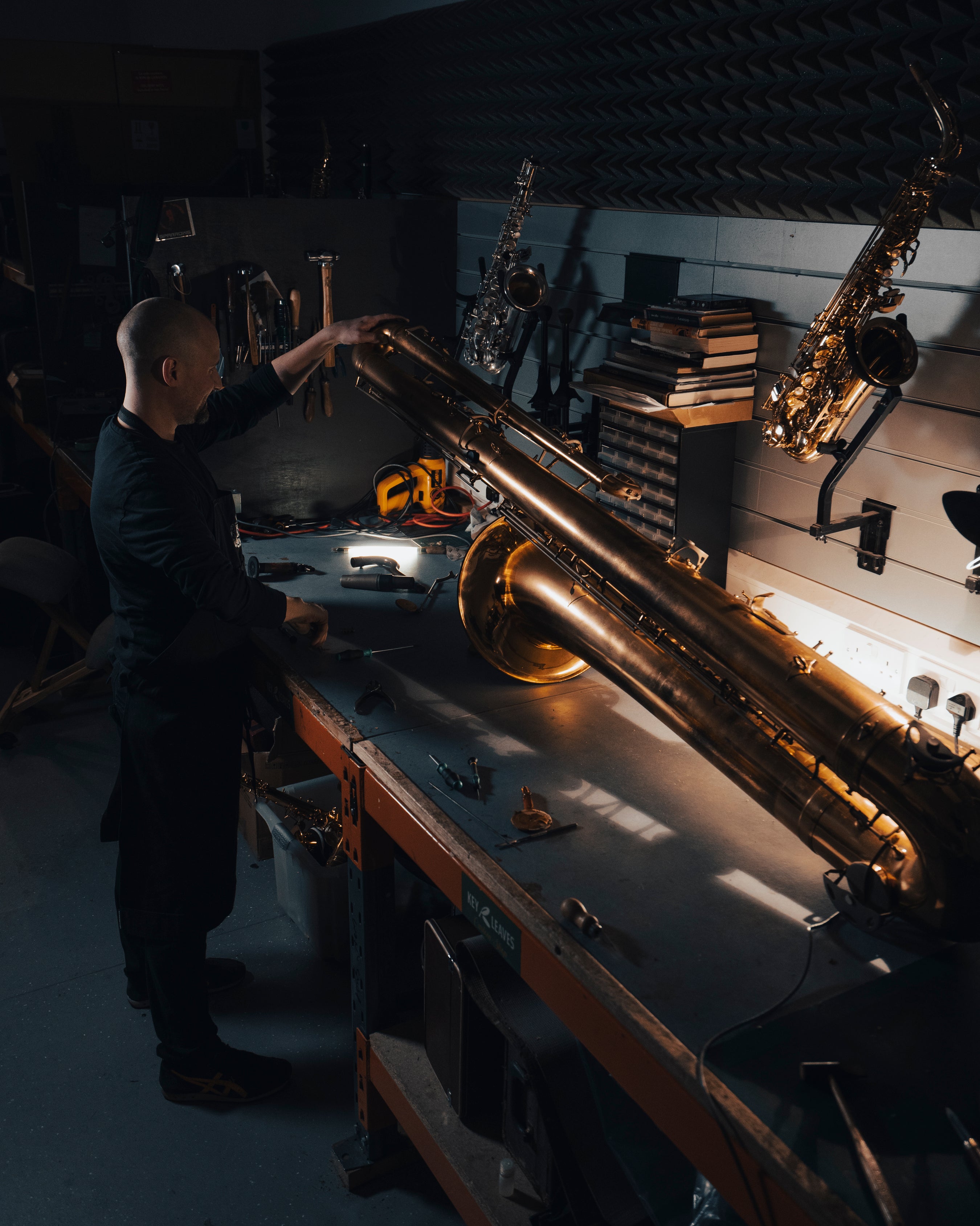 A saxophone being carefully worked on in the SAX workshop